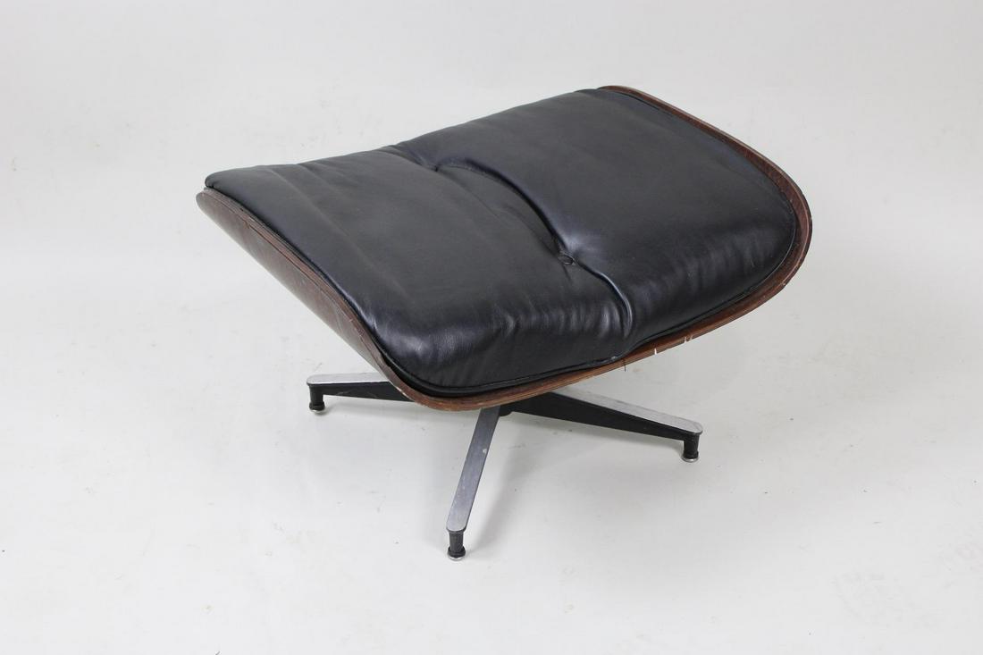 Eames Herman Miller Tufted Black Leather Ottoman for Lounge Chair: Eames Herman Miller Tufted Black Leather Ottoman for Lounge Chair. Ottoman in the iconic Eames is upholstered in black leather and has 5 feet, topped with veneer matching the underside of the seat. Di