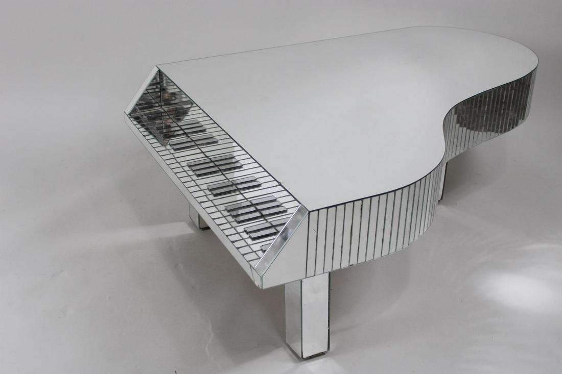 Mid Century Modern Mirrored Piano Shaped Coffee Table: Mid Century Modern Mirrored Piano Shaped Coffee Table. This is a statement piece! All mirrored piano table. Dimensions are 18 in h x 35.5 in w x 47.5 in d. Condition is very good. A few cracks to the