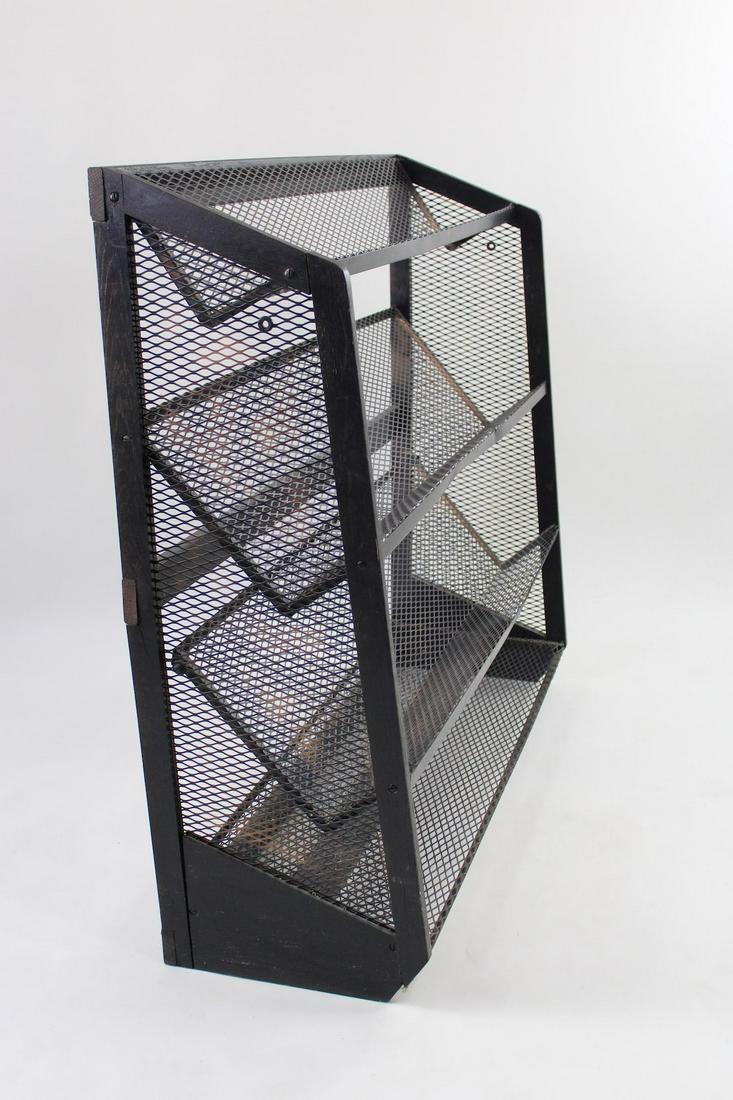 Industrial Black Metal Mesh Display Rack: Industrial Black Metal Mesh Display Rack. Four tier rack has 3 slanted shelves and is framed in wood. Dimensions are 45 in h x 48 in w x 13.25 in d. Condition is good with all shelving sturdy but shel