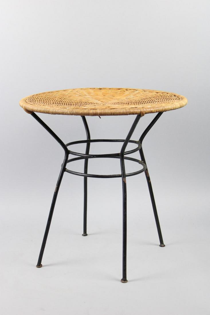 Mid-Century Modern Wrought Iron Wicker Side Table: Mid-Century Modern Wrought Iron Wicker Side Table. This is a fantastic circular side table. It has thin wrought iron legs and a woven wicker top. Dimensions are 18.5 in h x 18 in w x 18 in d. Conditio