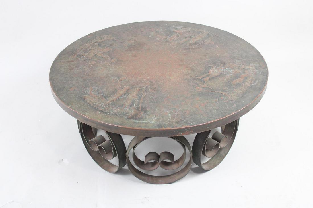 Round Coffee Table w/Wrought Iron Base & Embossed Copper Top: Round Coffee Table w/Wrought Iron Base & Embossed Copper Top. Fabulous table has a scrolled wrought iron base and copper top embossed with medieval imagery. Great patina. Dimensions are 16 in h x 38.5