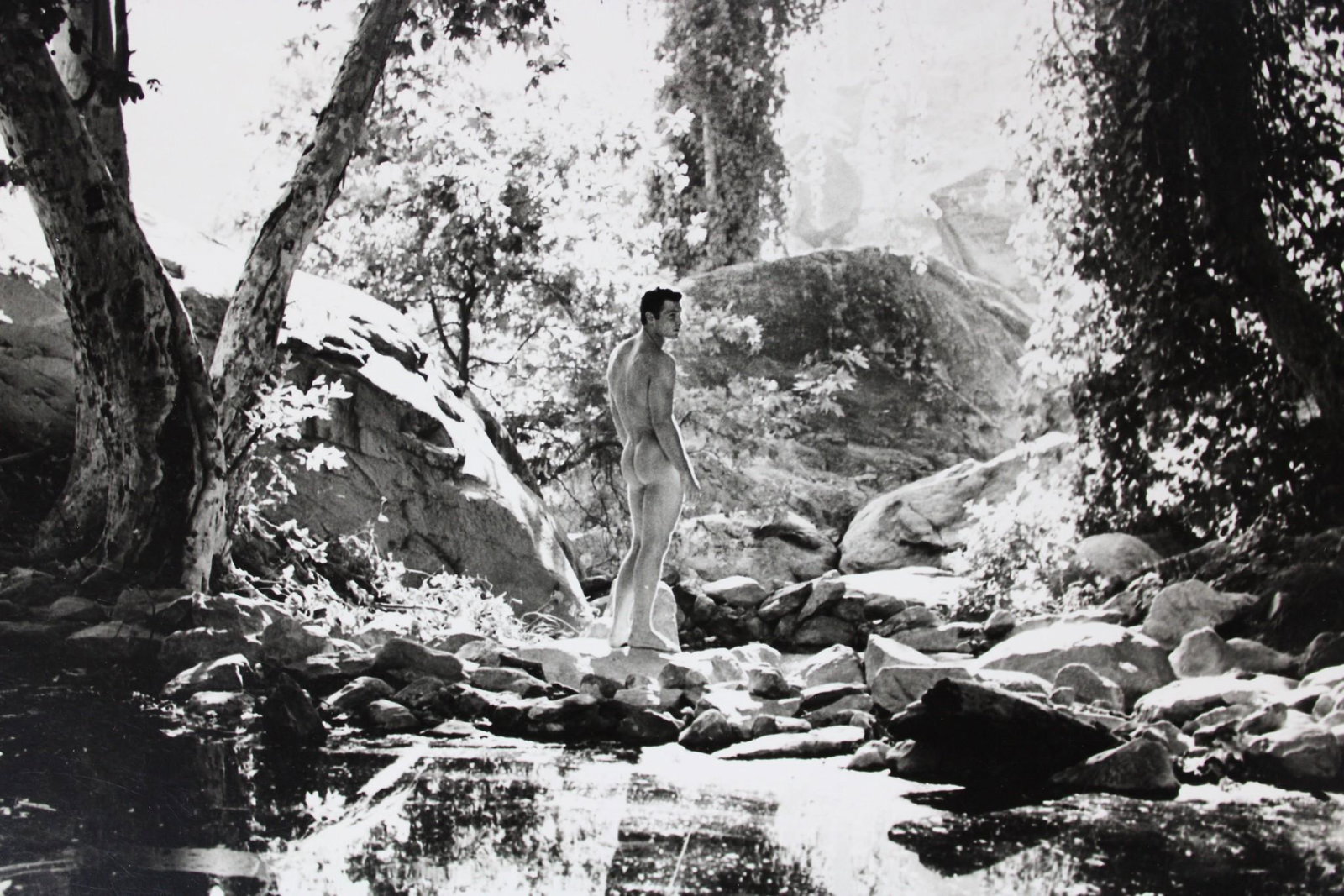 Roy Dean Photographs; Nude Male from "A Time in Eden": Roy Dean Briitish American Photographer (1925-2002). Pair of B&W photographs of a nude male in the outdoors for Roy Dean's first published book, A Time in Eden. Quantity: 2 Size 14 x 11 in Photographe