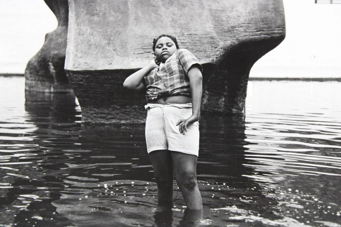 Eric Kroll Photograph; Portrait of Girl in Fountain: Eric Kroll, American Photojournalist b. 1946. This is a fantastic photograph of a girl standing in a fountain. It is labeled on the back. This photograph is not dated but it is from 1968-1983. Quantit