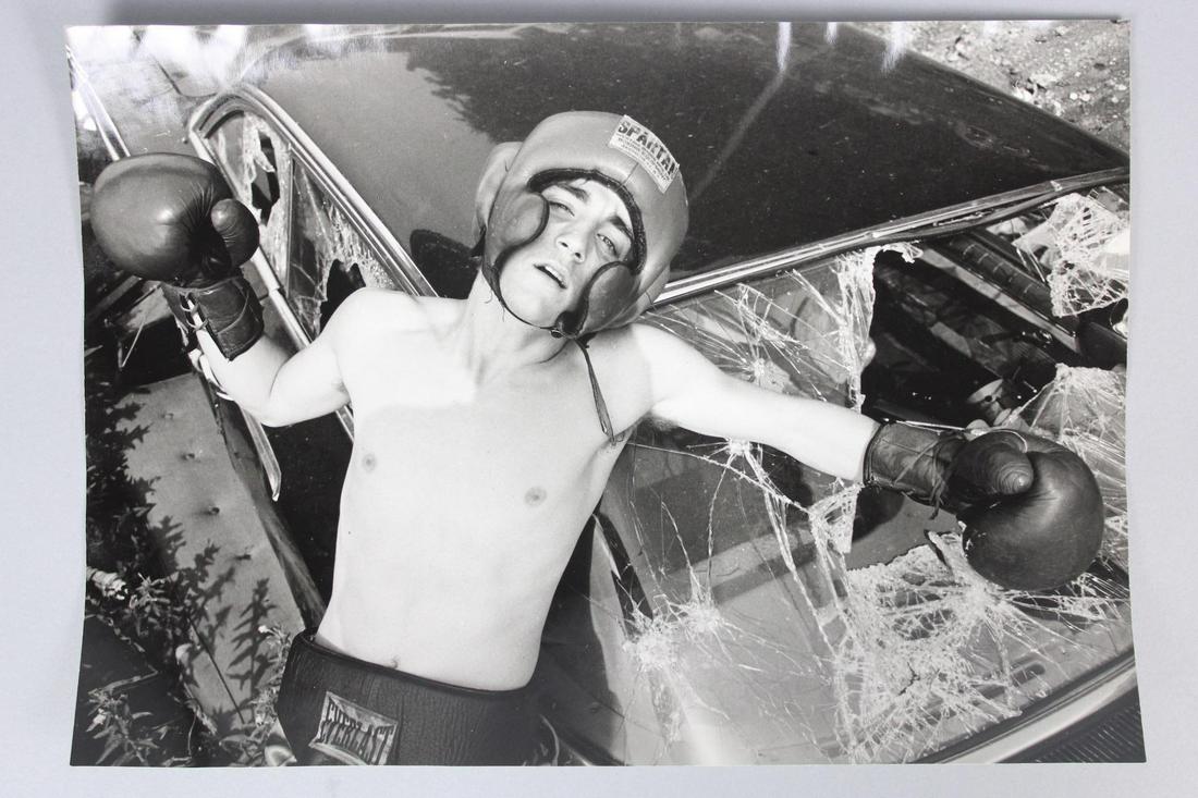 Jurgen Vollmer Photograph; Boxer in Car Crash: Jurgen Vollmer Photograph German Photographer b.1939. Single B&W photo of a boxer, knocked against a crashed car. This photo is undated but from 1968-1983. From the archive of After Dark Magazine. Qua