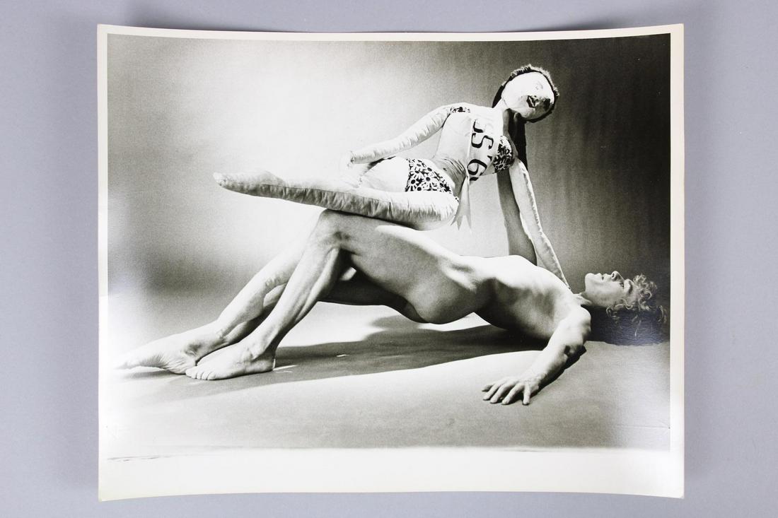 Kenn Duncan Photograph; Nude Male w/Lifesize Doll: Kenn Duncan American Photographer 1928 -1986. Single B&W photo of Nude Male w/Lifesize Doll, who is wearing a sash that begins with "Miss..." Undated but are from 1968-1983. Quantity: 1 Size 14 x 11 i