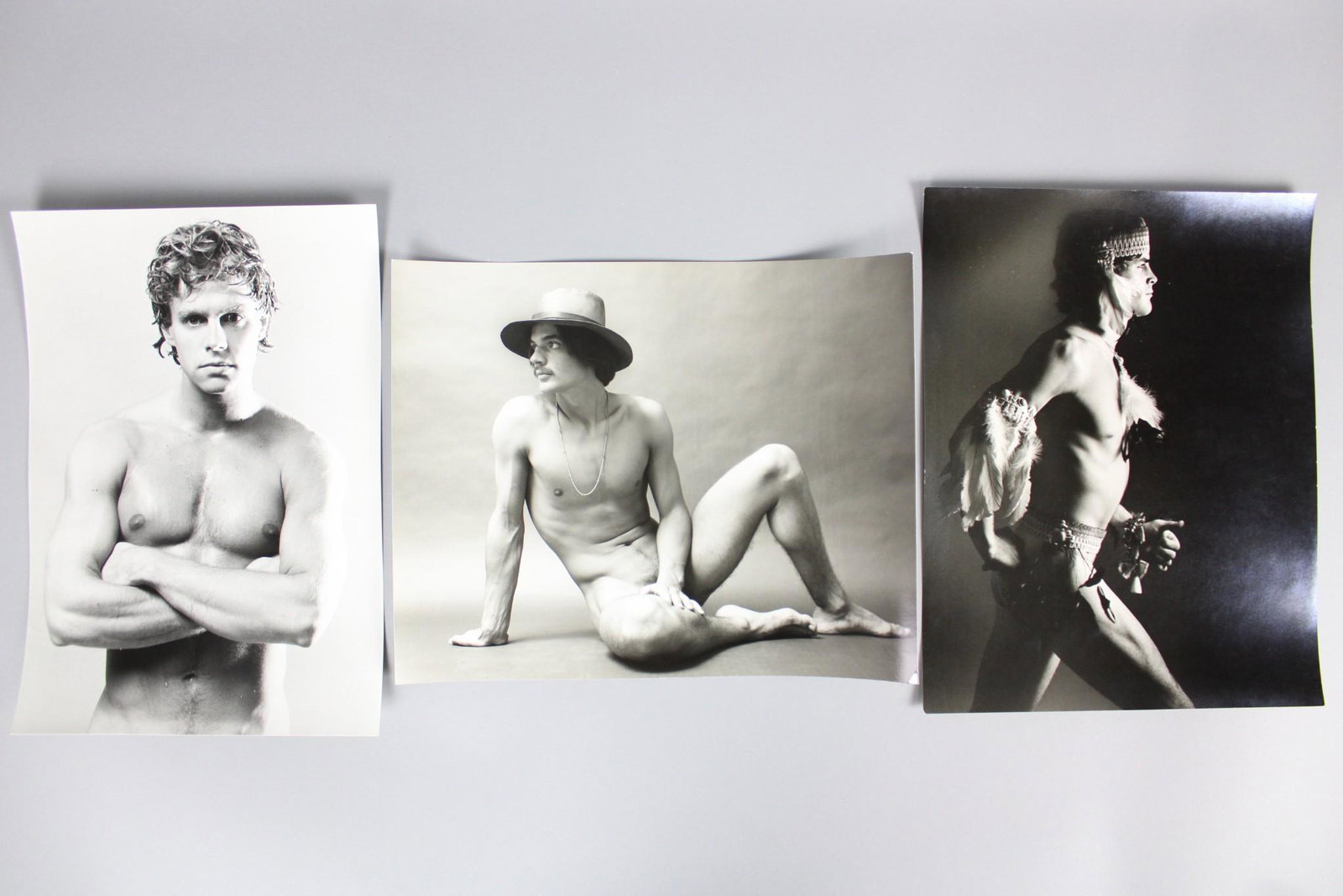 Kenn Duncan Photographs; 1970s Male Fashion incl. Nudes, Gay Interest: Kenn Duncan American Photographer 1928-1986. Lot of 16 B&W photos of men in great 1970s fashion, including some nudes as well as feathers, a guitar, stripes, a white flowy caftan and more. Undated but