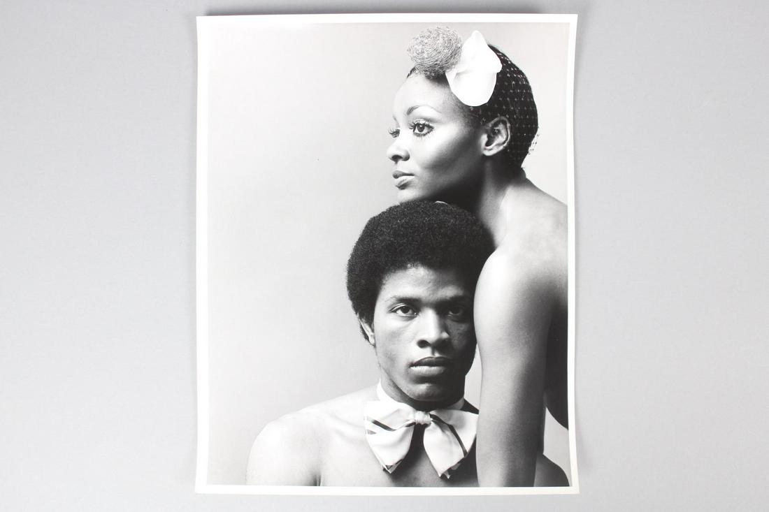 Kenn Duncan Photographs; Portrait of Shirtless Black Models Wearing Bow Ties: Kenn Duncan American Photographer 1928 -1986. This is a fantastic portrait photograph of a black couple. The woman has her chin placed on the male models head. Quantity: 1 Size 14 x 11 in Photographer