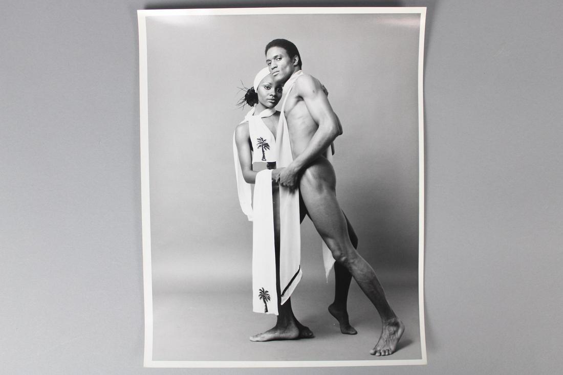Kenn Duncan Photographs; Portrait of Shirtless Black Models Wearing Bow Ties 1 of 3: Kenn Duncan American Photographer 1928 -1986. This is a fantastic standing portrait photograph of a black couple. They have long white scarves draped over their necks. This is the first photograph in 