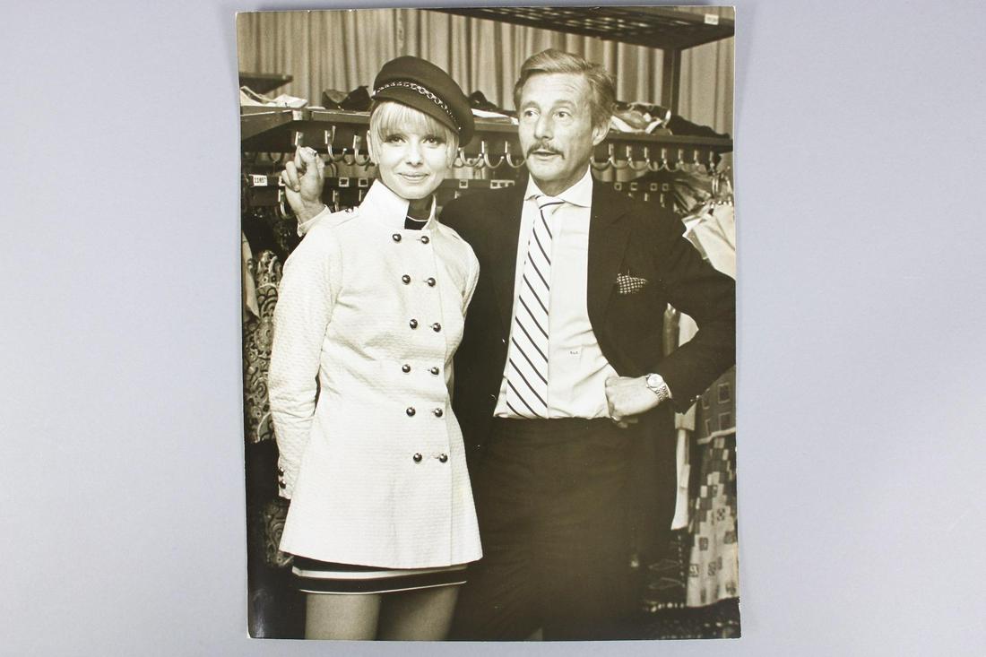 Ron Galella Photograph; Oleg Cassini w/Model: Ron Galella American Photographer 1931-2022. This is a great photograph of the fashion designer Oleg Cassini with model. It is copyrighted 1967 on the back. Quantity: 1 Size 14 x 11 in Photographer: R