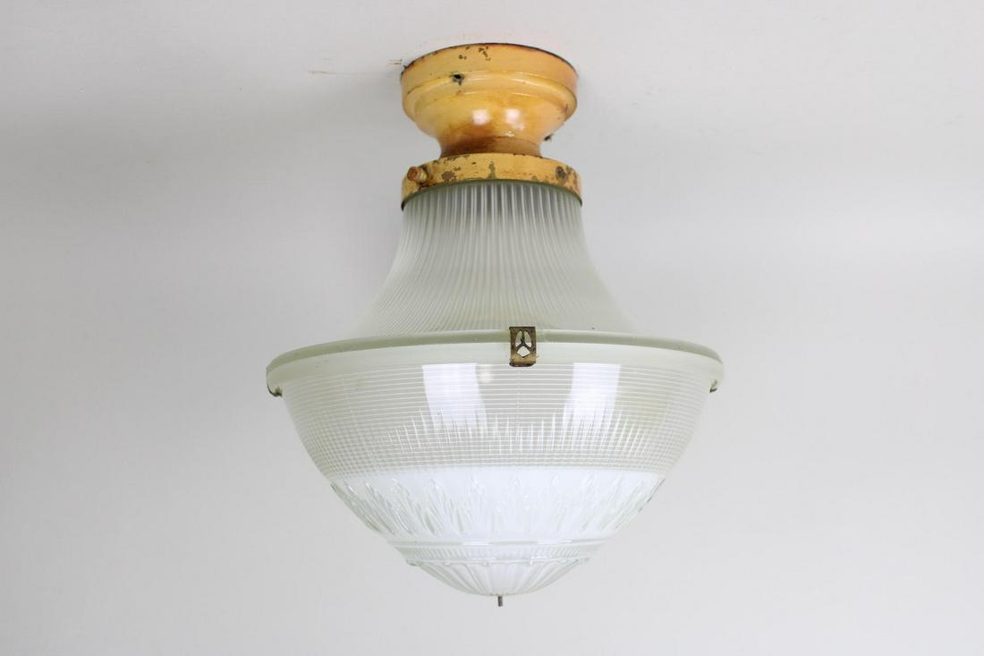 Art Deco Holophane Flush Mount Ceiling Light: 3 Piece Holophane Flush Mount Ceiling Light c. 1920s. Wonderful light fixture has a two-part prismatic glass shade with original clips and metal mount. The lamp has not been tested for function and ma