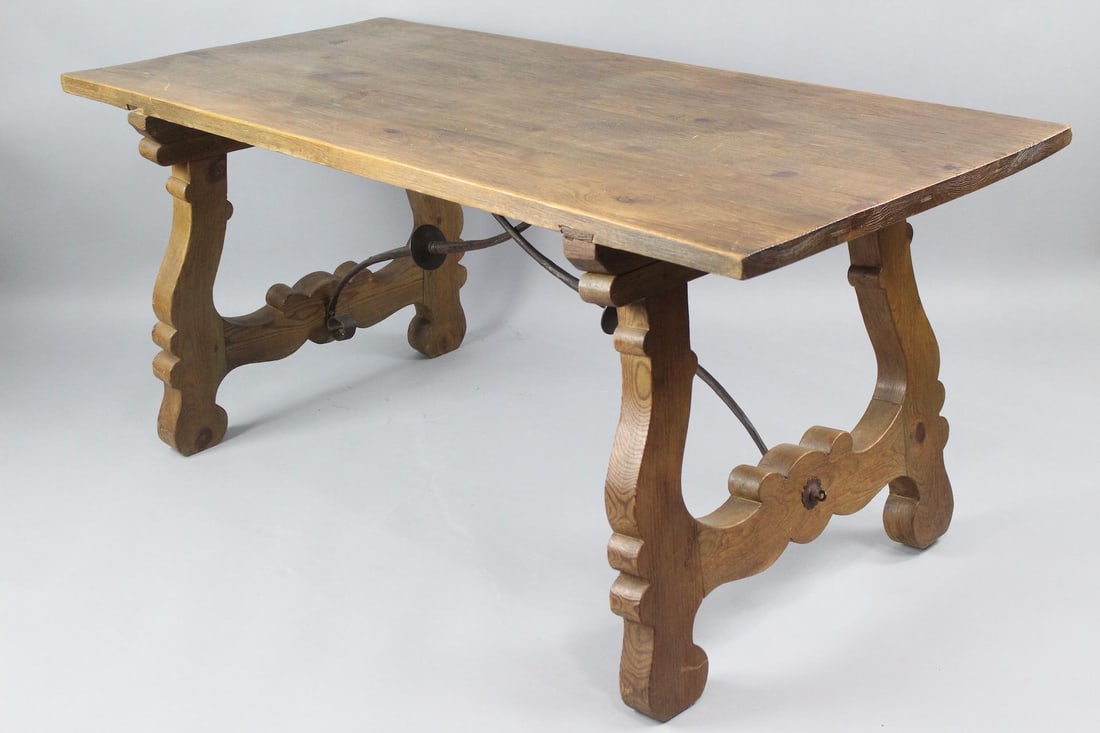 Spanish Carved Lyre Leg Dining Table, Wrought Iron Trestle: Spanish Carved Lyre Leg Dining Table, Wrought Iron Trestle. This minimalist wooden table carved decoration in the two legs with trestle support in the likeness of curved crossed swords. Dimensions are