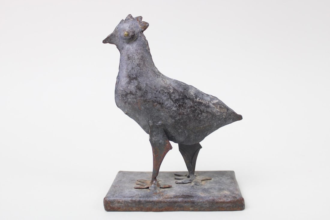 Welded Metal Folk Art Chicken Sculpture: Welded Metal Folk Art Chicken Sculpture. This small and lightweight statue or bookend has primitive cut contours and folded metal pieces to construct the bird shape, with gold painted eyes, standing o
