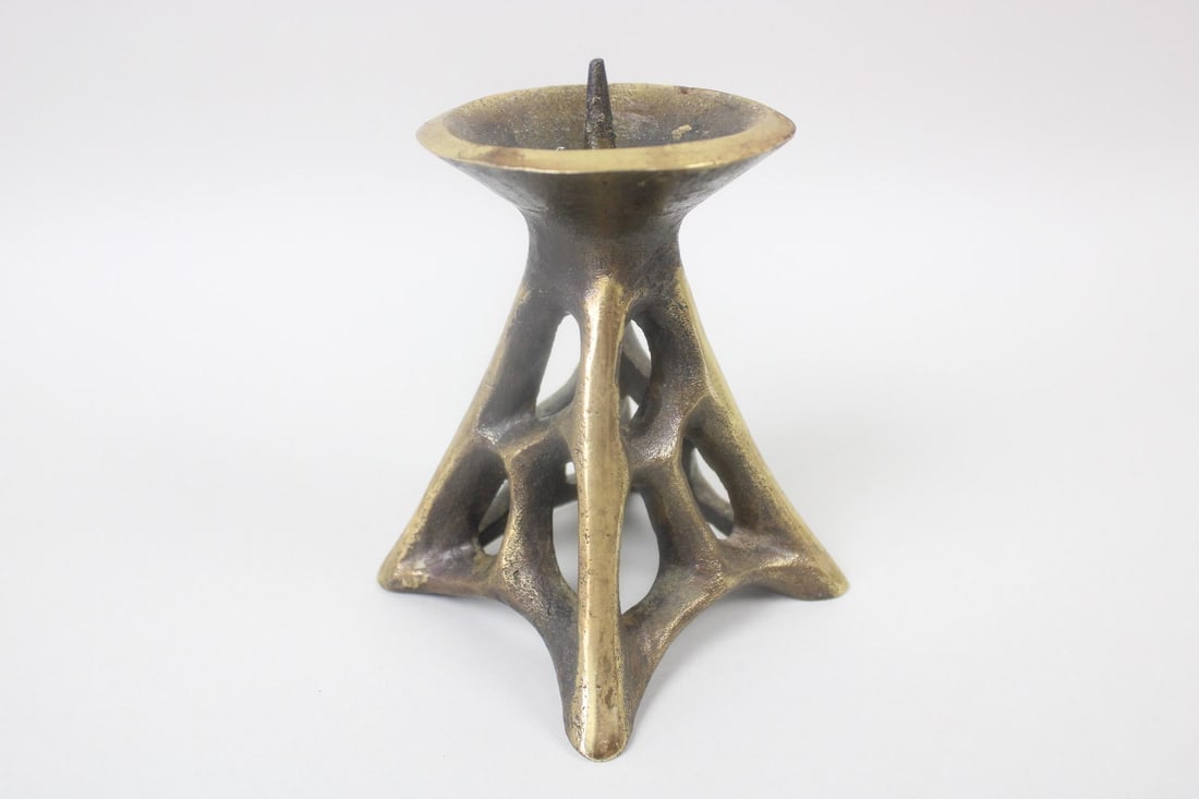 Brass Brutalist Candle Stand, Mid Century Modern: Brass Rhizome Candle Holder Stand. Pyramid shaped with a webbed pattern to metal base and a spike for holding a candle in place. Dimensions are 6.5 in h x 4.5 in w x 4.5 in d. Condition is good with s