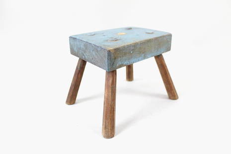 Primitive Blue Folk Art Stool: Small Blue Folk Art Stool. This small primitive stepstool or child's stool has a squared edge seat top and angled legs, painted a light blue on top. Dimensions are 7 in h x 9.5 in w x 7.5 in d. Condit