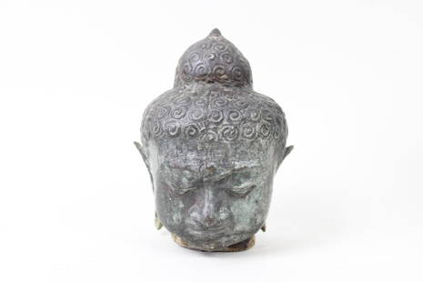 Bronze Meditating Buddha Head Statue: Bronze Meditating Buddha Head Statue. This hollow bronze cast of Buddha's head and face has downcast eyes as if in meditation, and curlicue swirl details all over the hair. Dimensions are 7 in h x 5 i