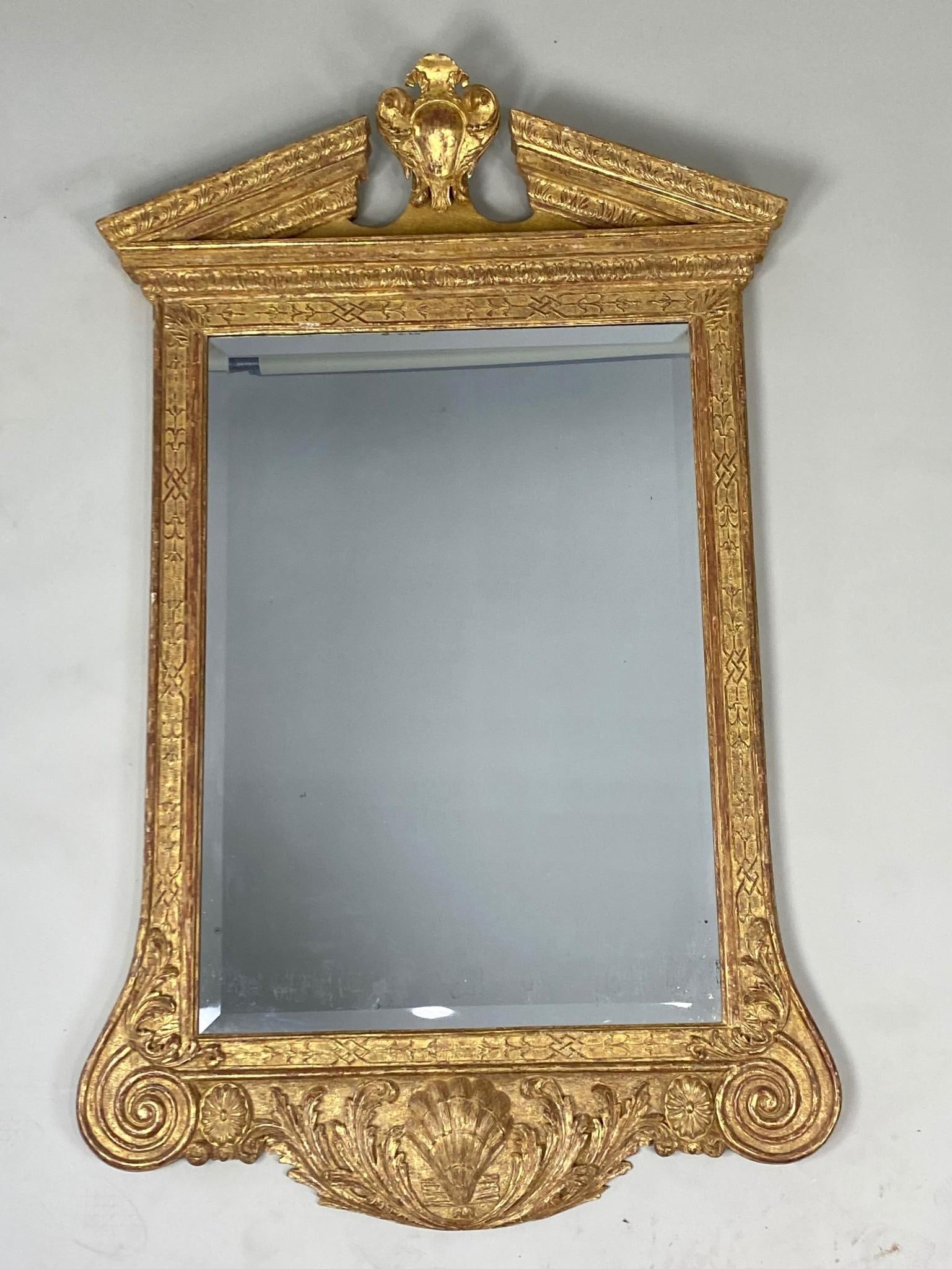 18th C. George II Giltwood Pier Mirror with Shell Motif, William Kent Style: George II Giltwood Pier Mirror with Shell Motif, William Kent Style. This tall Georgian mirror has an ornately carved thick wooden frame painted gold with repeating decorative patterns, scrolls in the