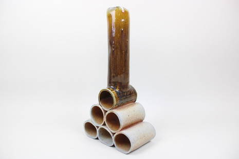 Arnie Zimmerman Sculptural Ceramic Cylinder Vase: Arnie Zimmerman Sculptural Ceramic Cylinder Vase. On a pyramid base of stacked open cylinder tubes, this ceramic pottery vessel has an upright tube on top, glazed in yellow brown paint, with speckled