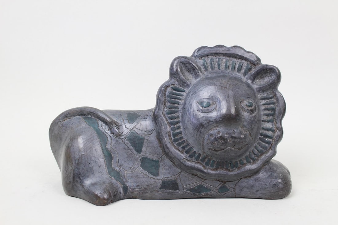 Mid Century Modern Figural Lion Sculpture: Reclining Figural Lion Sculpture, Painted Coat & Mane. This hand carved and etched hollow figurine of a lion cat has textured face details and green painted accents, including a diamond style pattern