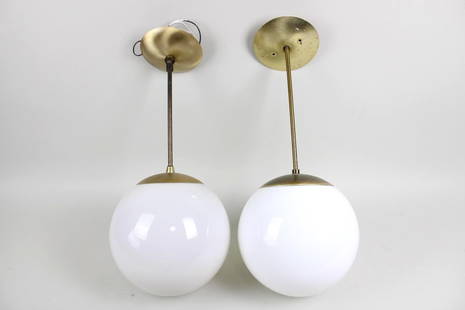 Pair of Mid-Century Modern Brass Globe Orb Lamps: Pair of Mid-Century Modern Brass Globe Orb Lamps. These two minimalist lights have brass metal ceiling caps, straight brass suspension rods, and matching caps that hold in the white sphere shades. Dim