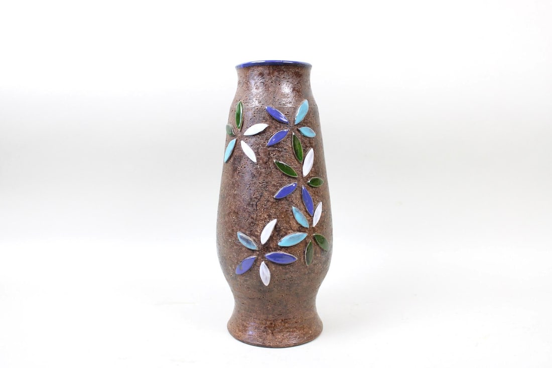 Mid-Century Modern Raymor Pottery Vase by Aldo Londi: Mid-Century Modern Raymor Pottery Vase with Applique Flowers. This brown ceramic vessel is painted blue on the inside and has green, blue, and white flower petals applied to the exterior. Marked on bo