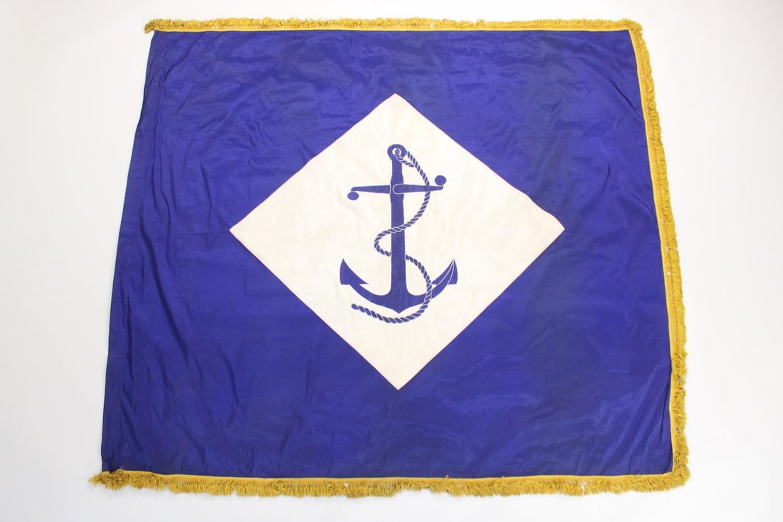 US Naval Battalion Flag with Gold Fringe: US Naval Battalion Flag with Gold Fringe. Blue & white US Navy flag with appliqued anchor & diamond on a satin background. From the Rungee Flag Museum. Dimensions are 72 in h x 84 in w x .1 in d. Cond