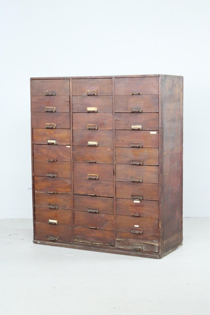 Industrial 30-Drawer Wooden Multidrawer Cabinet: Industrial 30-Drawer Wooden Multidrawer Cabinet. This large drawer unit has 30 uniform pull drawers, some with label frames, and can be used as a card catalog or storage for studio or work tools.Dimen