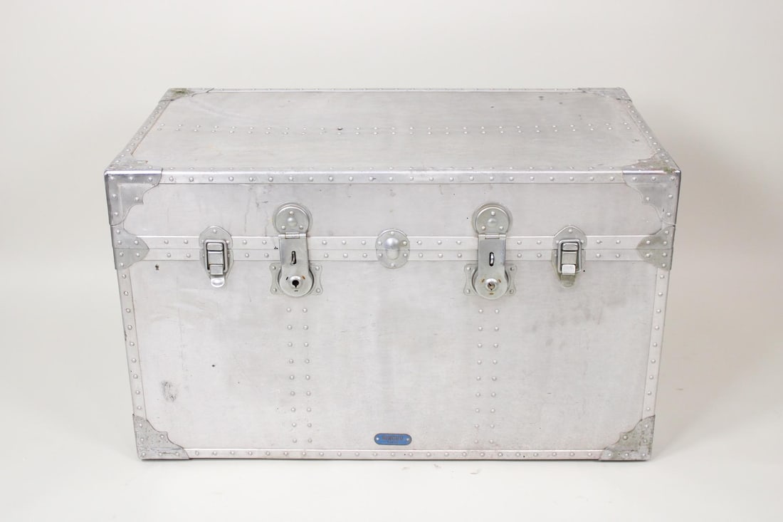 Industrial All Aluminum Trunk by Rikuko: Industrial All Aluminum Trunk by Rikuko. This machine age trunk has a dark green interior. Dimensions are 24 in h x 40 in w x 22 in d. Condition is good, some small dents, opens and closes easily. Ple