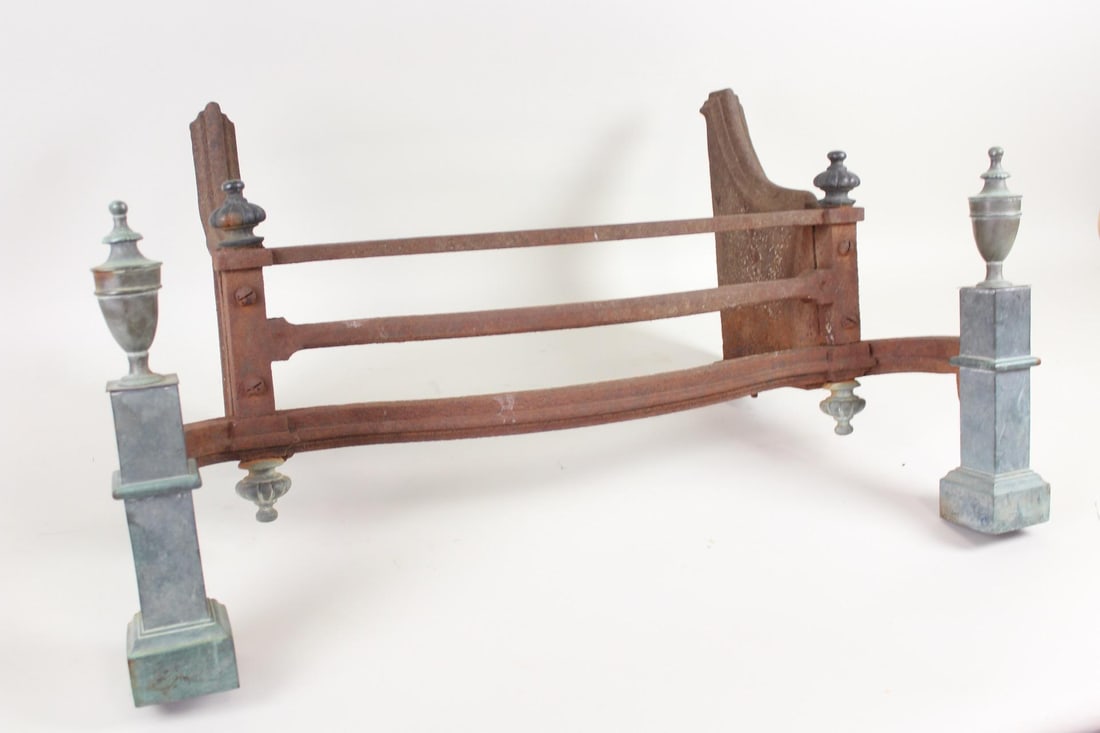 Antique Iron & Bronze Fireplace Grate: Antique Iron & Bronze Fireplace Grate. This industrial metal barrier has a minimalist iron bar fender adorned with architectural bronze finials and columns.Dimensions are 18 in h x 33.5 in w x 15.75 i