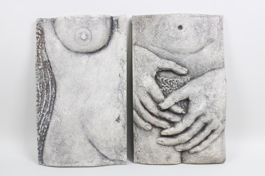 Pair of Erotic Plaster Wall Sculptures, Nude Male & Female: Pair of Erotic Plaster Wall Sculptures, Nude Male & Female. These small grey wall hangings portray close-up images of nude bodies in a textured plaster. Unsigned. Dimensions are 9 in h x 4.75 in w x 1