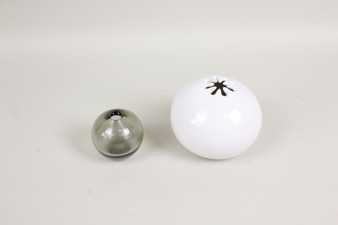 Pair of Minimalist Small Round Bud Vases, Holmegaard & Bennington Potters: Pair of Minimalist Small Round Bud Vases, Holmegaard & Bennington Potters. This lot includes 1 translucent smoked glass vase with slightly tapered flat base and small circular bud opening, and 1 white