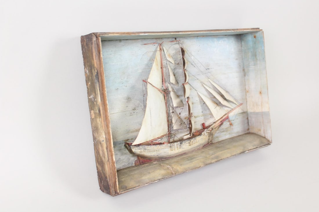 19th C. Folk Art Shadowbox Sail Boat Model, J.W. Thorne: Framed Shadowbox Sail Boat Model, J.W. Thorne. This 3D wooden sailboat model is half-mounted to a wooden case frame, with nautical sea scenes painted on the background and sails meant to appear billow