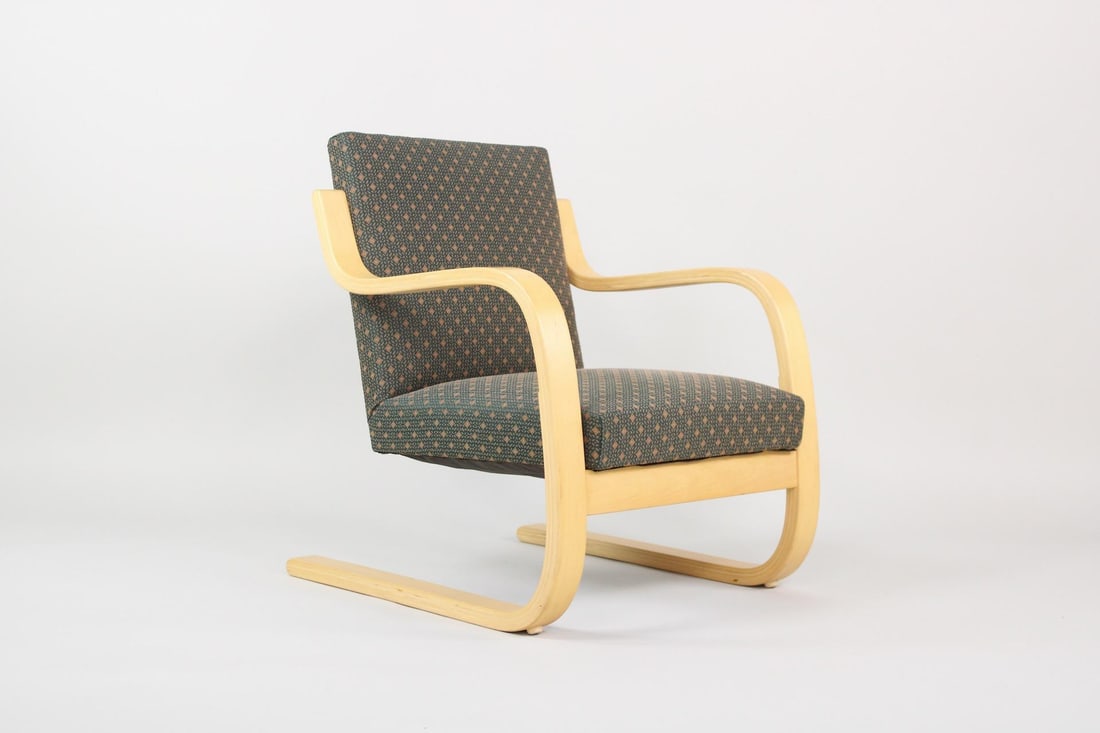 Alvar Aalto '402' Atelje Lounge Chair, ICF: Alvar Aalto '402' Atelje Lounge Chair. This armchair has a bentwood blond wood frame with cantilever floating seat upholstered in a green and orange fabric. Marked with a sticker from ICF, this is the