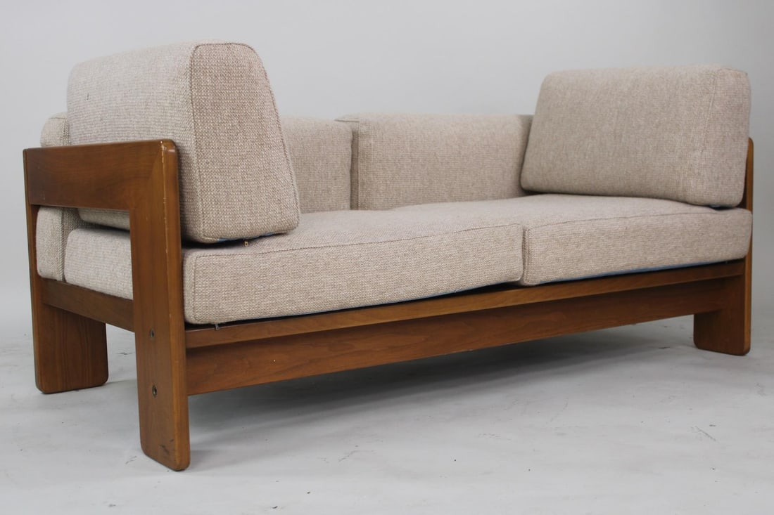 Tobia Scarpa 'Bastiano' Loveseat for Knoll: Mid-Century Modern Tobia Scarpa 'Bastiano' Loveseat for Knoll. This two-seater has a cubist wooden frame supporting the deep beige colored fabric upholstered cushions and large side pillows. Marked wi