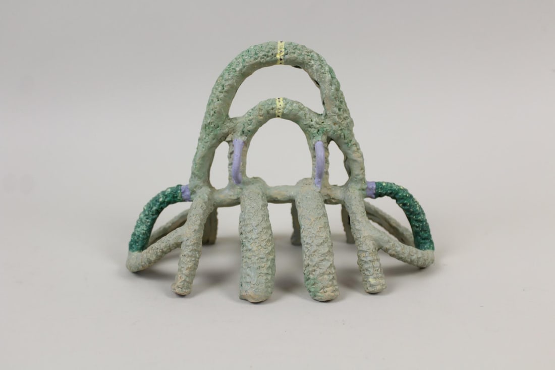 Abstract Clay Sculpture, Green Rib Cage Spider: Abstract Clay Sculpture, Green Rib Cage Spider. This handmade piece has a symmetrical spider like stance with support legs protruding from each side and a tiered handle top. No maker's mark, this is b
