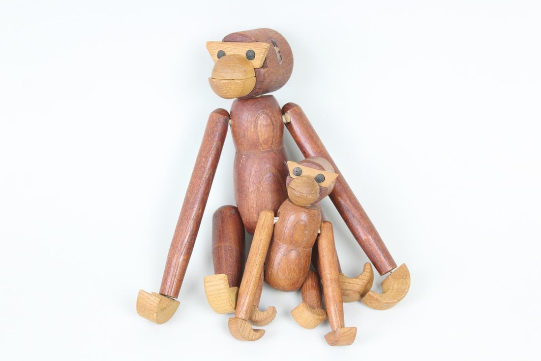Pair of Mid-Century Kay Bojesen Style Articulating Wood Monkeys: Pair of Mid-Century Kay Bojesen Style Articulating Wood Monkeys. These teak carved wooden animals have curved feet and hand pieces, geometric body parts, and jointed limbs. Marked with a sticker by Vi