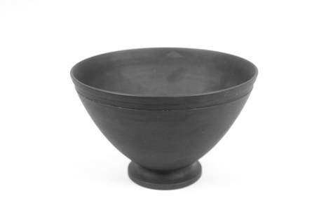 Keith Murray Wedgwood Basalt Footed Bowl: Keith Murray for Wedgwood Art Deco Black Basalt Footed Bowl. With matte finish, marked Wedgwood, Made in England I 953. Dimensions are 4.25 in h x 6.5 in w x 6.5 in d. Condition is good with minor wea