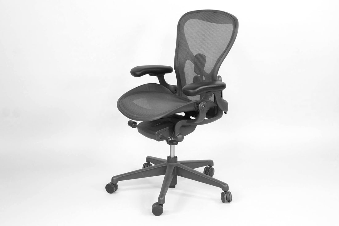 Black Herman Miller Aeron Chair: Black Herman Miller Aeron Office Desk Chair. Contemporary adjustable chair, with Herman Miller Aeron sticker on underside. Dimensions are 41 in h x 27 in w x 27 in d. Seat height is 22 in. Condition i