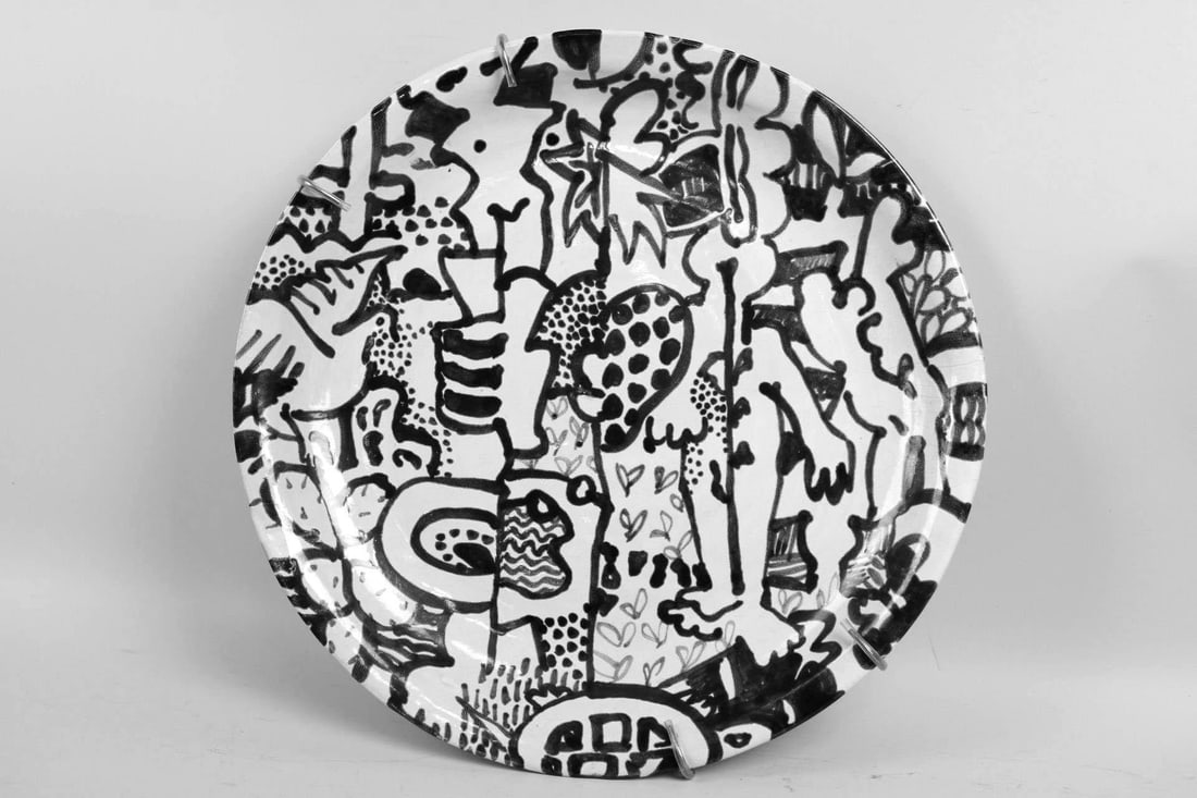 Large Ceramic Plate Artist Decorated Abstract Nudes: Large Plate with Hand Painted Abstract Nudes. This round dish has an abstract design with various patterns and shapes including nude figures, and comes with a metal spring holder that grips the top an