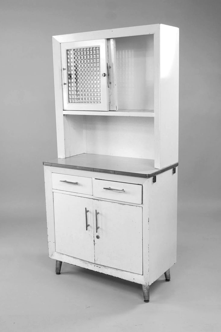 Art Deco White Metal Hoosier Style Kitchen Cabinet: Art Deco White Enamel Hoosier Style Kitchen Larder Cabinet. This tall standing pantry on raised cone feet features an industrial metal frame with glass front top cabinet doors to cubby storage with gl