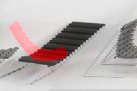 Pair of Michel Boyer Bauhaus Boudins Lounge Chairs: Pair of Michel Boyer Bauhaus Boudins Lounge Chairs. Chairs in the style of Michel Boyer (no labels or tags) with tubular metal frames and cushioned seats, with one in red and the other black. Dimensio