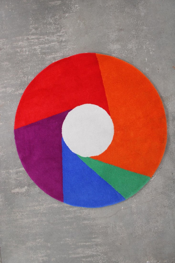 Max Bill Metrocs Wool Color Wheel Rug: Max Bill Metrocs Wool Color Wheel Rug. The max, biena + jakob bill foundation rug designed by Max Bill, based on graphic art. It is hand-crafted in Japan and the made of wool. This rug retails new for