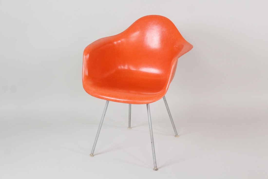 Herman Miller Eames Armchair in Red Orange: Mid Century Modern Herman Miller Eames Fiberglass Armchair in Red Orange. Classic chair retaining a still vibrant red orange color. Marked underneath. Dimensions are 31 in h x 25 in w x 22.5 in d. Sea