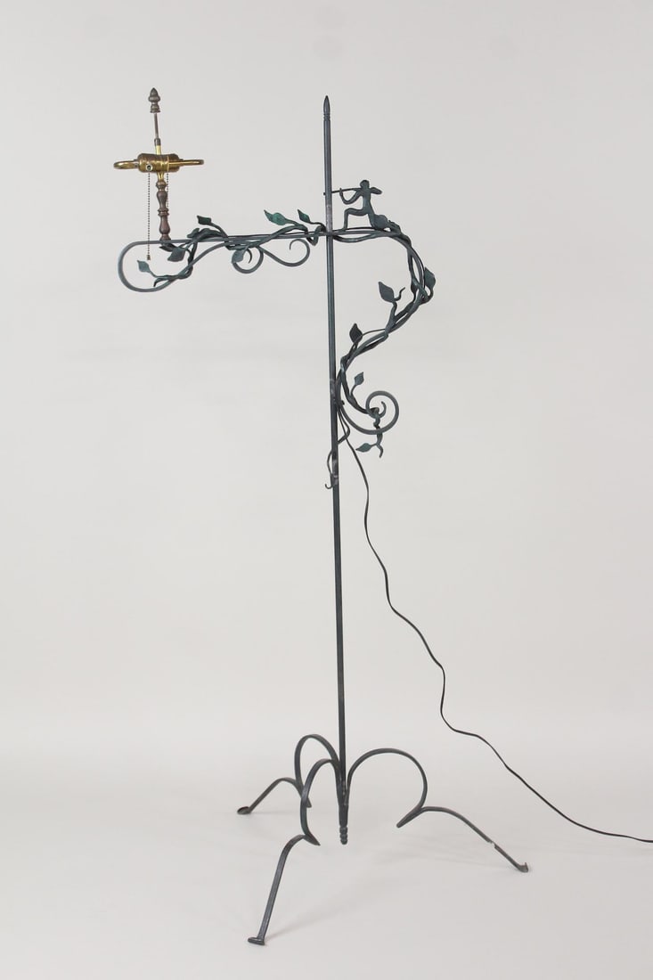 Figural Hunter Wrought Iron Floor Lamp, Wilhelm Hunt Diederich Style: Wrought Iron Hunting Scene Floor Lamp, Wilhelm Hunt Diederich Style. This standing light is wrought iron with a green Bronzed patina on it. It has a decorative tripod base and sculptural vines and lea