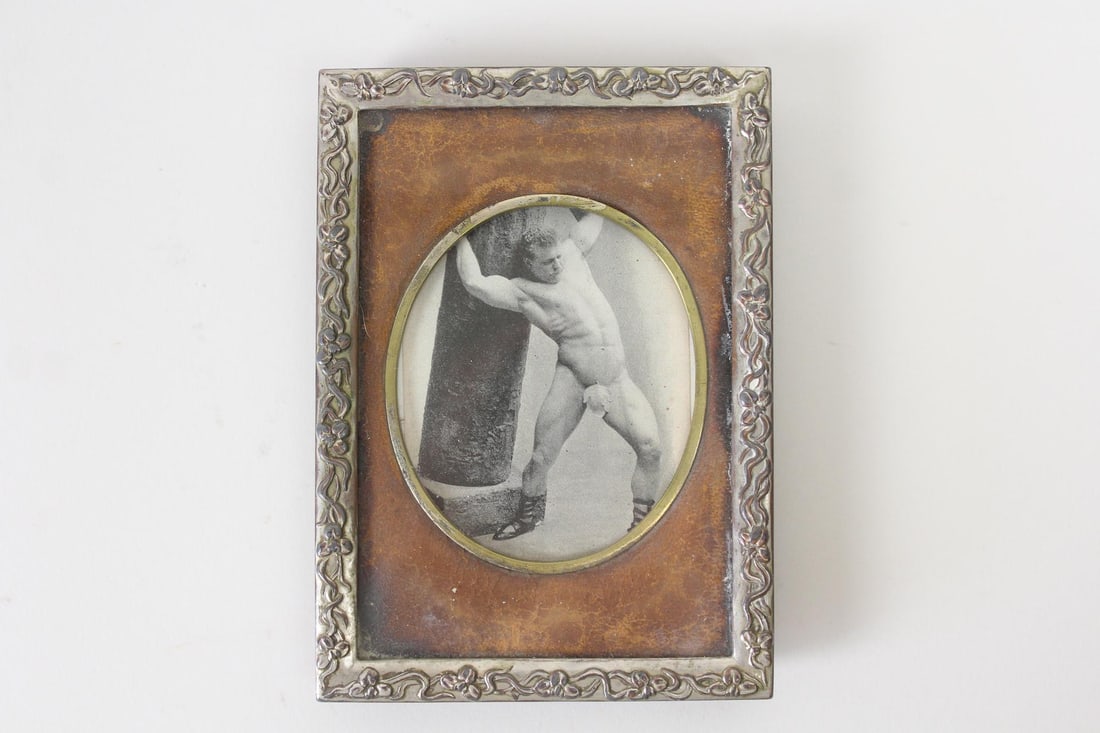 Framed Picture of Strongman Eugene Sandow, Gay Interest: Framed Picture of Eugene Sandow Strongman. Clipping from a period magazine of a nude Eugene Sandow (1867-1925,)a German Strongman and bodybuilder, with a fig leaf for modesty. In a small ornate metal 