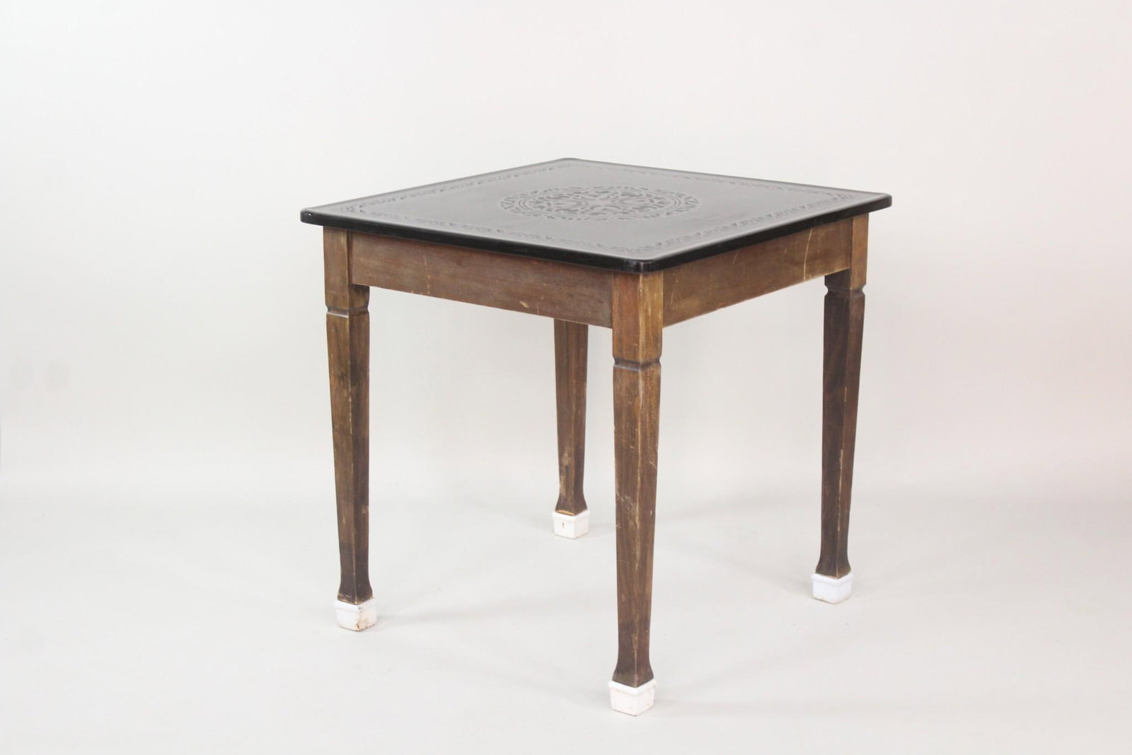 Black Vitrolite Etched Glass Top Cafe Table: Black Vitrolite Etched Glass Top Cafe Table. This industrial or commercial use table has enameled iron capped feet, common in some old cafe tables. The glass top is original to this table, it is not a