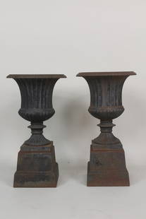 Pair of Antique Black Painted Cast Iron Urn Planters on Stands: Pair of Antique Black Painted Cast Iron Urn Planters on Stands. They could be used without the stands if needed, classic urn shape. Dimensions are 20 in h x 15 in w x 10.5 in d. Condition is good.