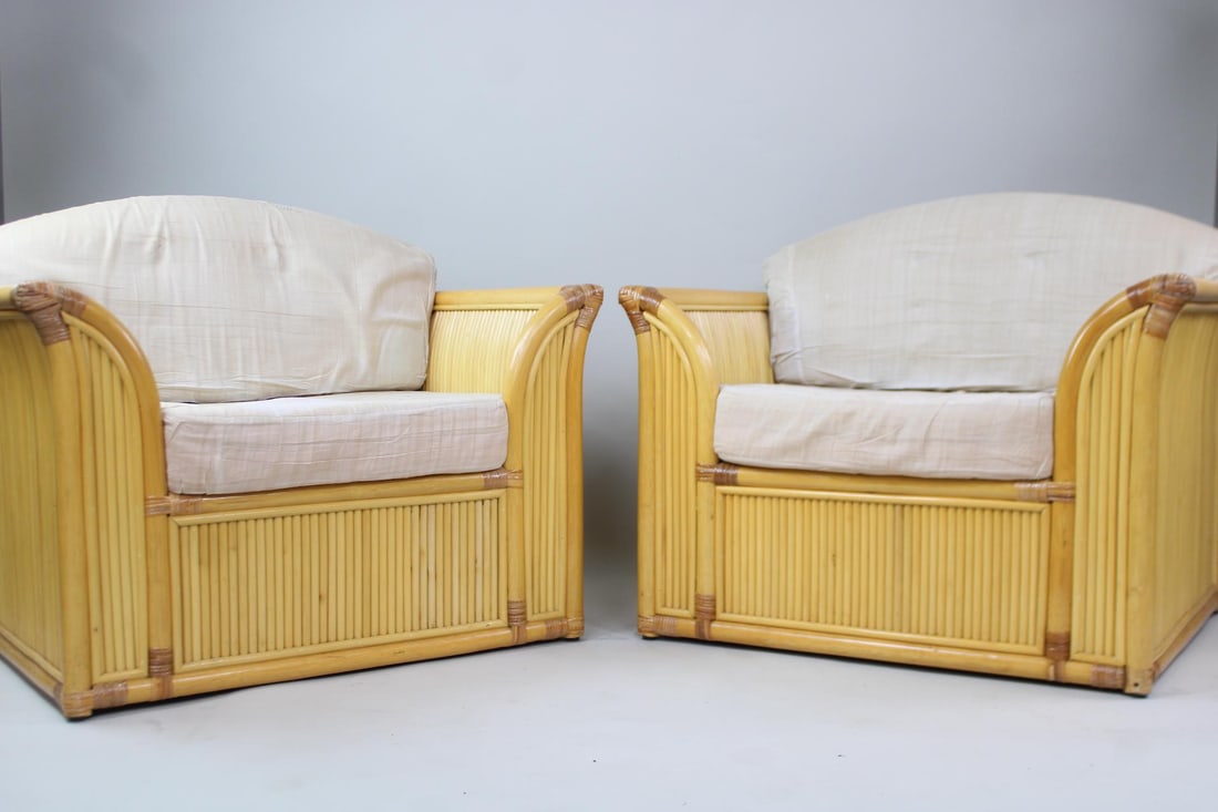 Pair of Curved Side Bamboo Club Chairs: Pair of Mid Century Modern Curved Side Bamboo Club Chairs. These chairs have a unique shape, very stylish. They have curved design. No makers mark. Dimensions are 30.5 in h x 36.5 in w x 28 in d. Seat