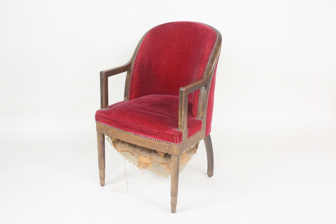 Walnut & Studded Red Velvet Armchair: Walnut & Studded Red Velvet Armchair. Early 20th century bergere with walnut frame, upholstered in red velvet and finished with studs. Christie's label attached. Dimensions are 35.5 in h x 21.75 in w