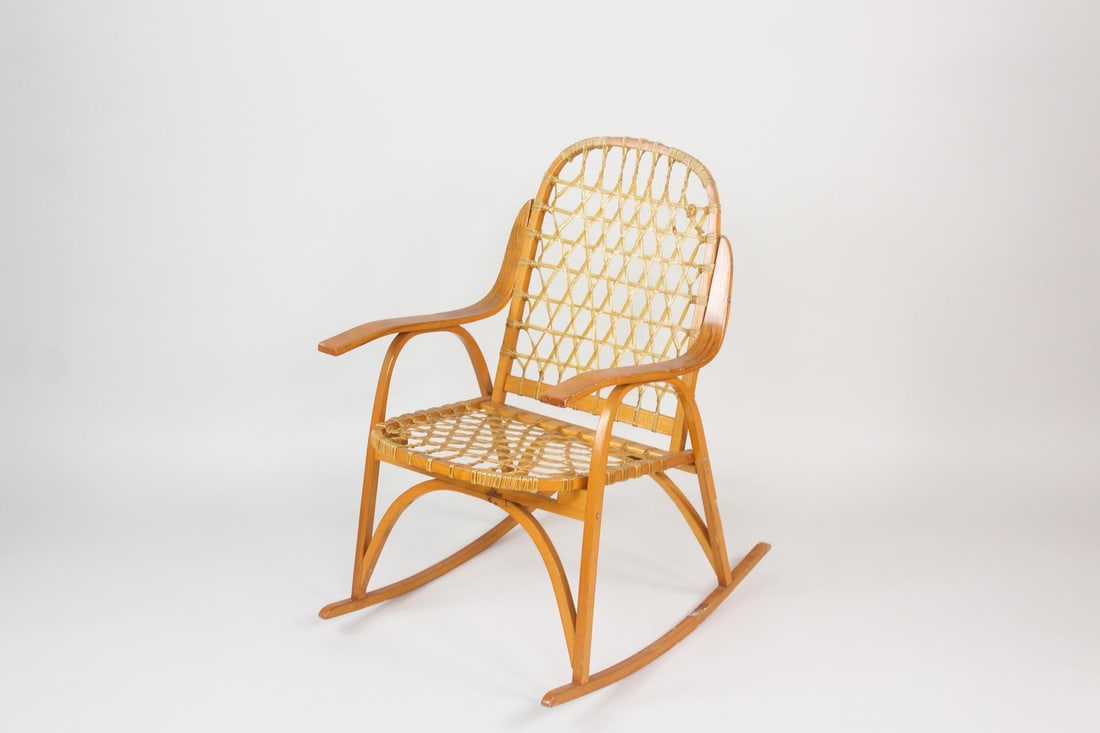 Snowshoe Rocking Chair by Snocraft: Snowshoe Rocking Chair by Snocraft. This is a unique chair made the same way snowshoes are made. It has mark from Manufacturer Snocraftfrom Norway, Maine. Dimensions are 34.5 in h x 21.5 in w x 26.5 i