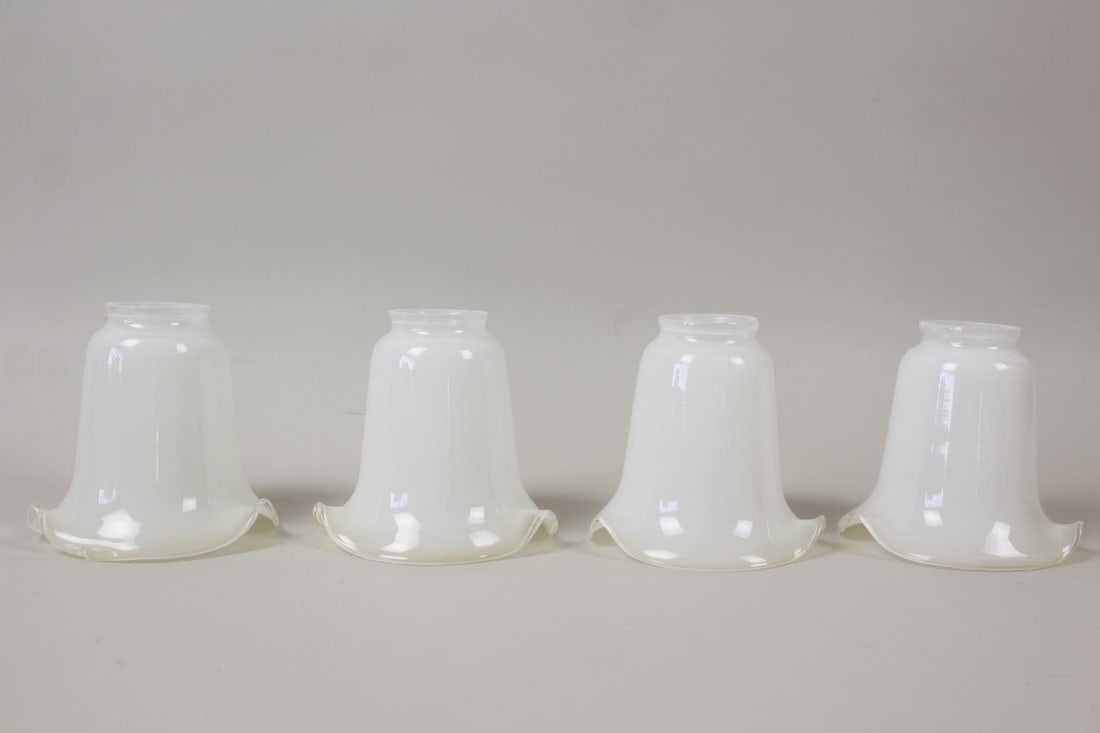 Set of 4 Tulip White Glass Lamp Shades: Set of 4 Tulip White Glass Lamp Shades. Matching set of shades, shaped like tulips or lilies. Dimensions are 5 in h x 5.25 in w x 5.25 in d. Condition is good with minor wear. Please call or email for